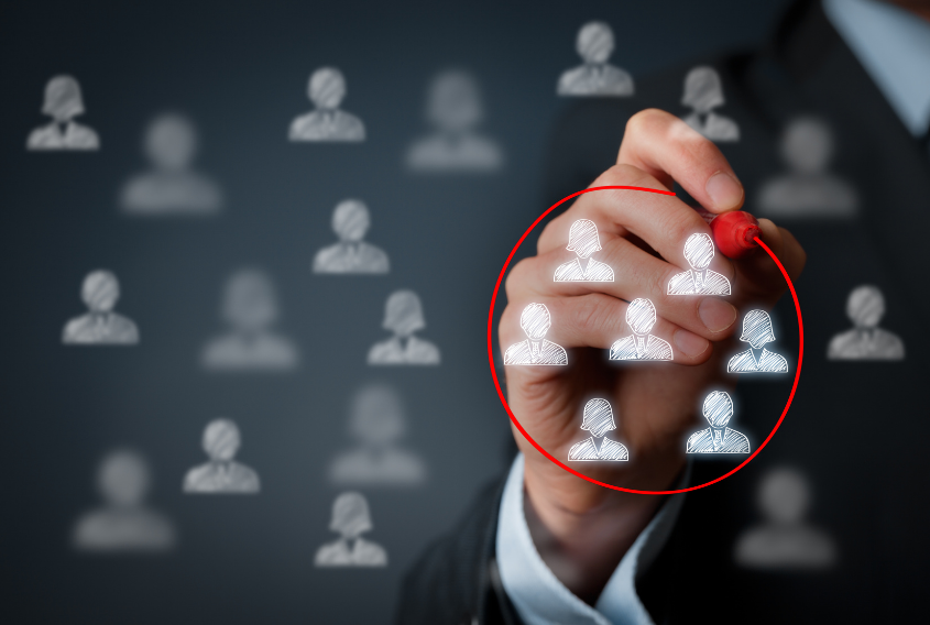 Hand circling a group of people icons